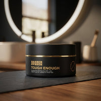 BARBER BARBER Tough Enough Styling Clay 100g - potje op donkere mat bij verlichte ronde spiegel