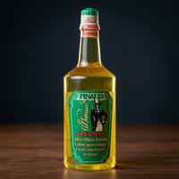 Ed. Pinaud Clubman Original Aftershave 370ml - fles op houten blad tegen donkere achtergrond