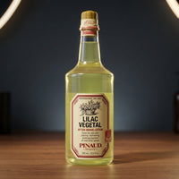Ed. Pinaud Lilac Vegetal - fles op houten blad tegen donkere achtergrond